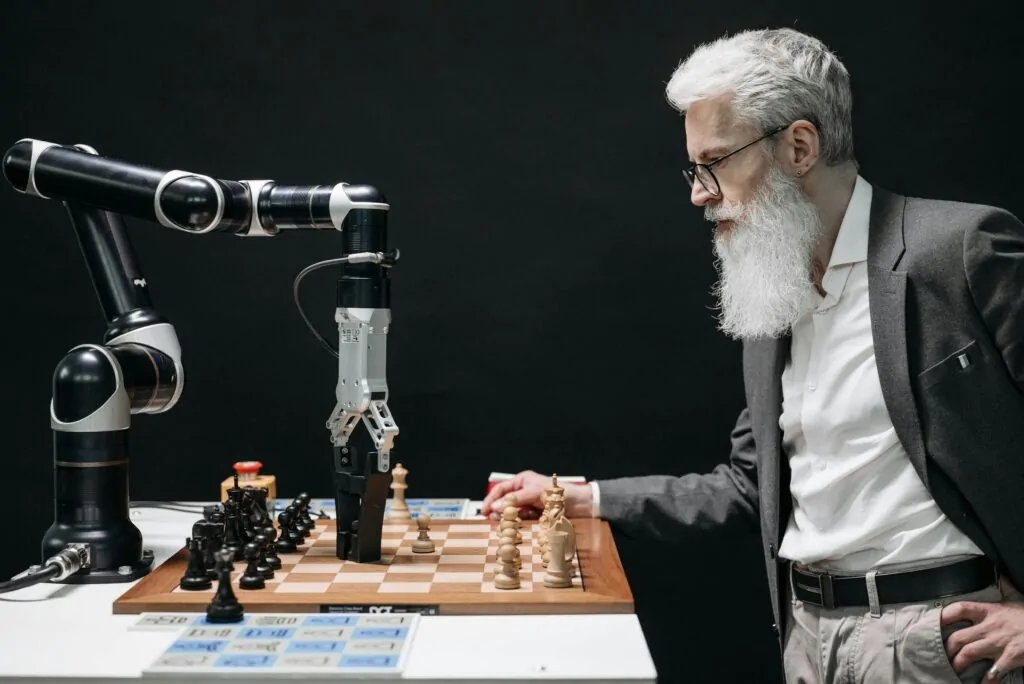 Robotic arm playing chess against a man. the rise of ai